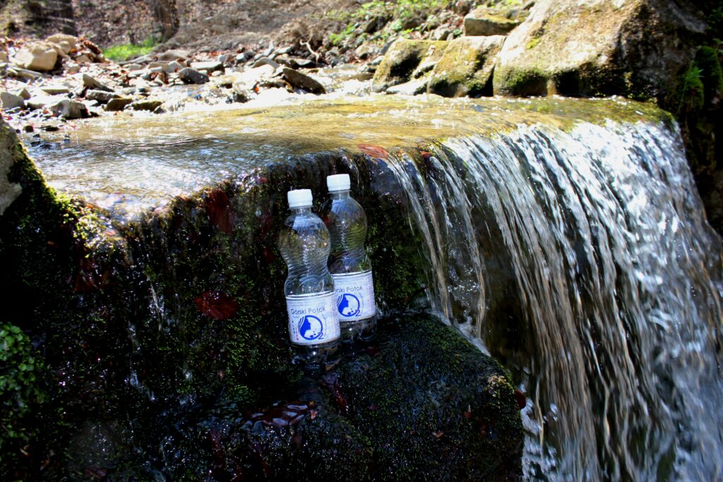 Flaschen Górski Potok plus tlen in einem Bergwasserfall